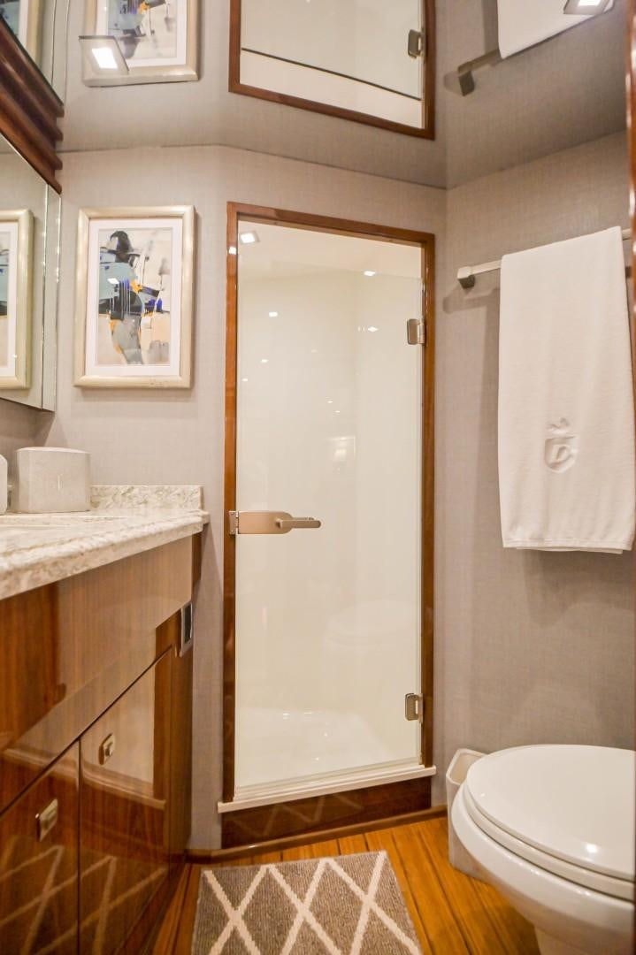 a bathroom with a door and a mirror aboard GOOSE Yacht for Sale