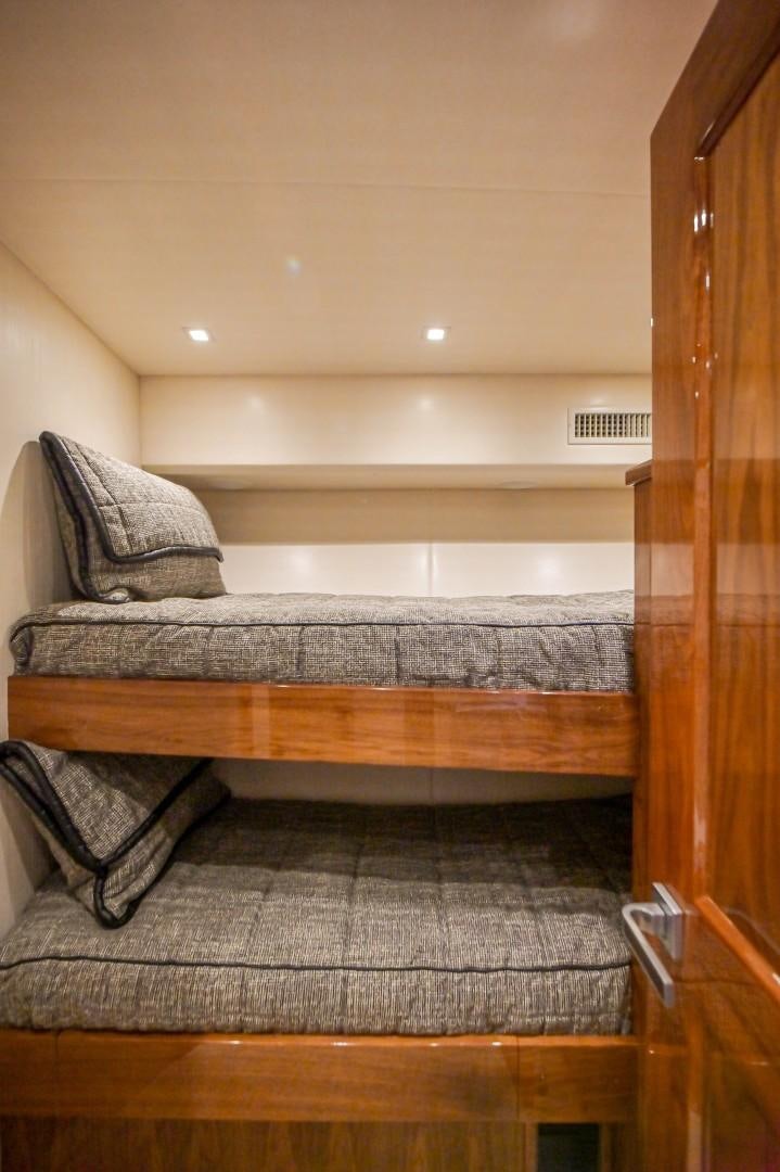 a bed with a wooden frame aboard GOOSE Yacht for Sale