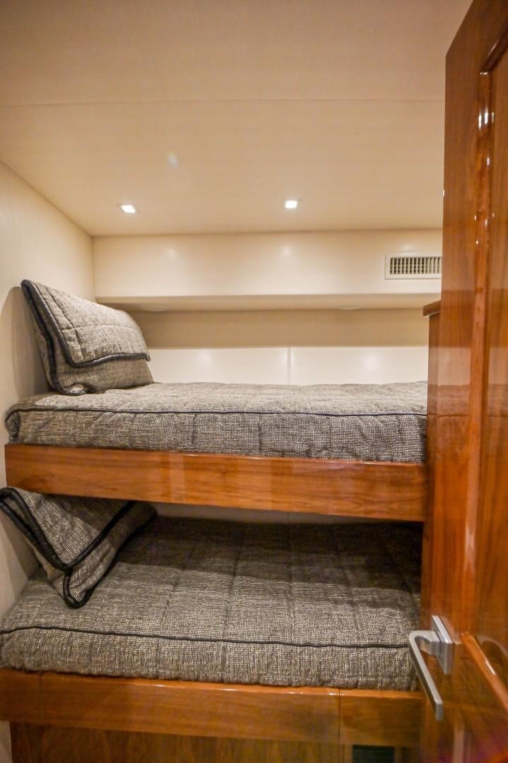 a bed with a white pillow aboard GOOSE Yacht for Sale