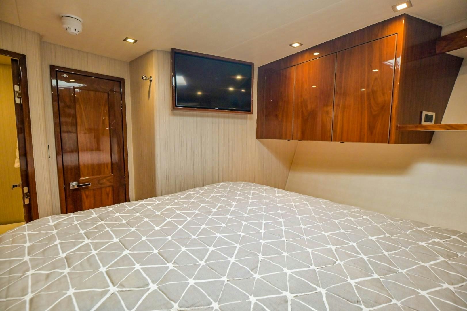 a bed with a television on the wall aboard GOOSE Yacht for Sale