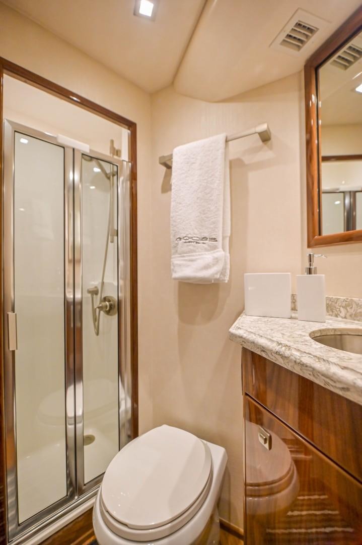a bathroom with a glass shower door aboard GOOSE Yacht for Sale