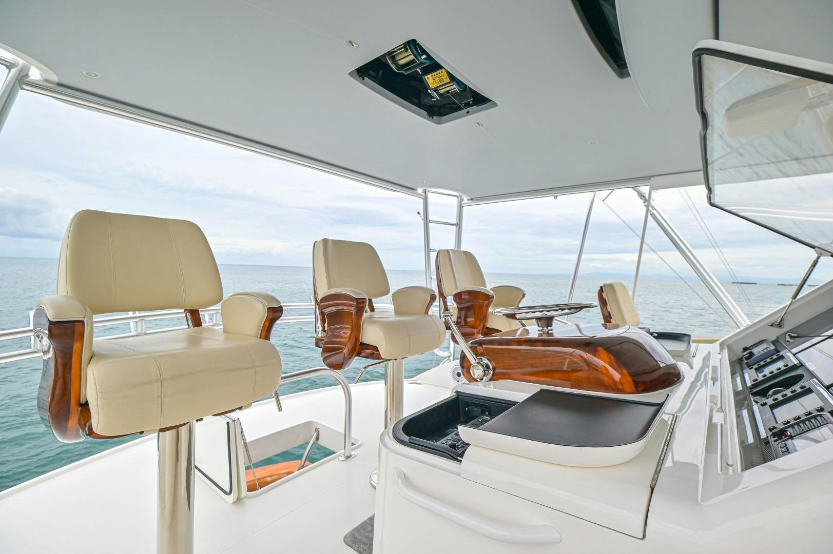 a white tent with chairs and a table with a computer on it aboard GOOSE Yacht for Sale