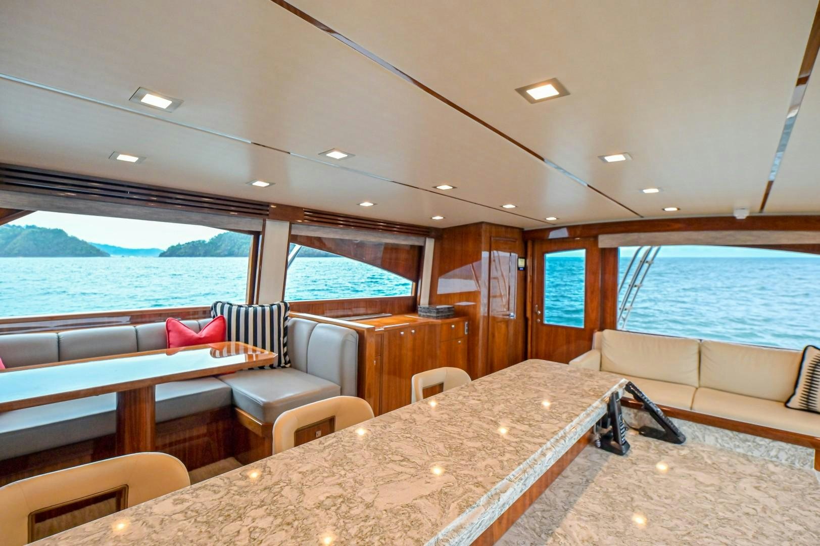 a large room with a large table and chairs aboard GOOSE Yacht for Sale