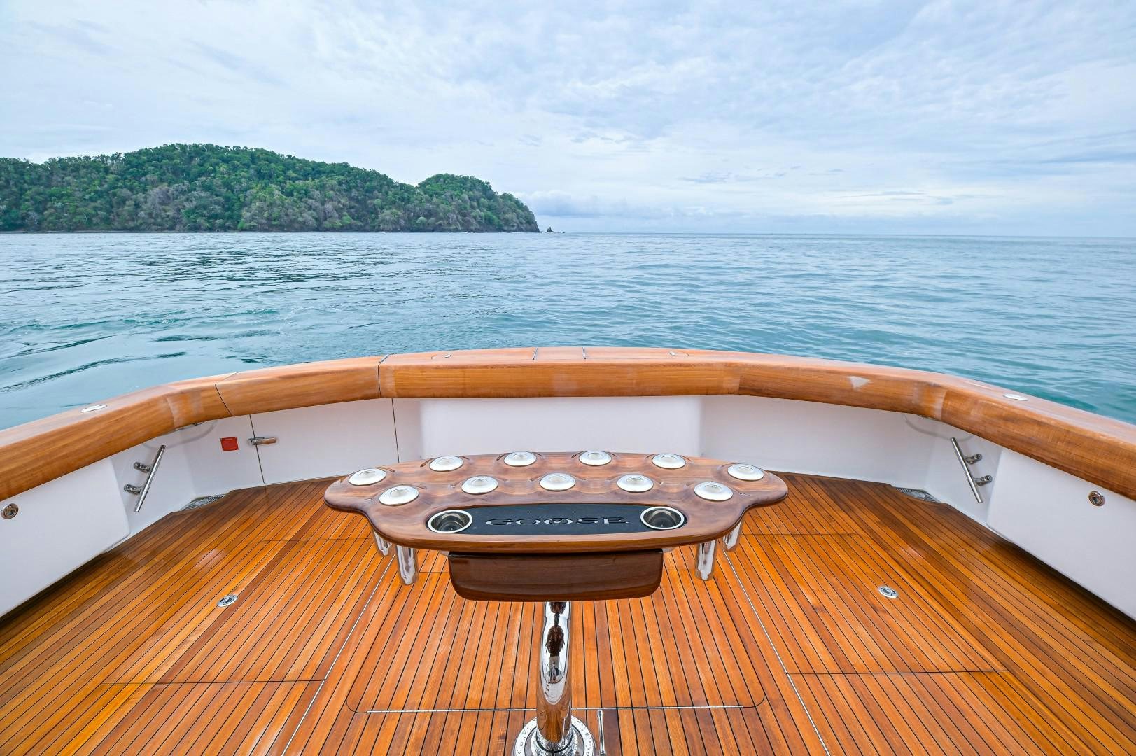 a wood boat on a body of water aboard GOOSE Yacht for Sale