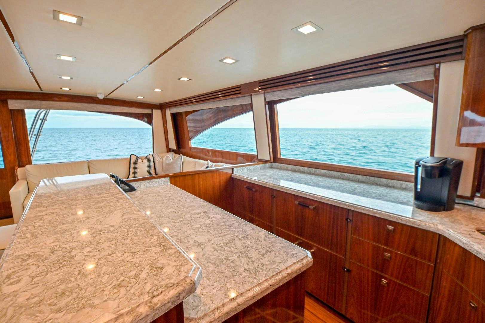 a kitchen with a large window overlooking the ocean aboard GOOSE Yacht for Sale