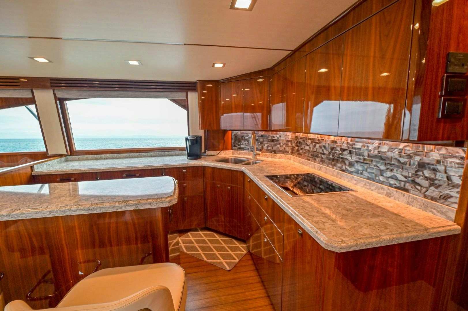 a large kitchen with wooden cabinets aboard GOOSE Yacht for Sale