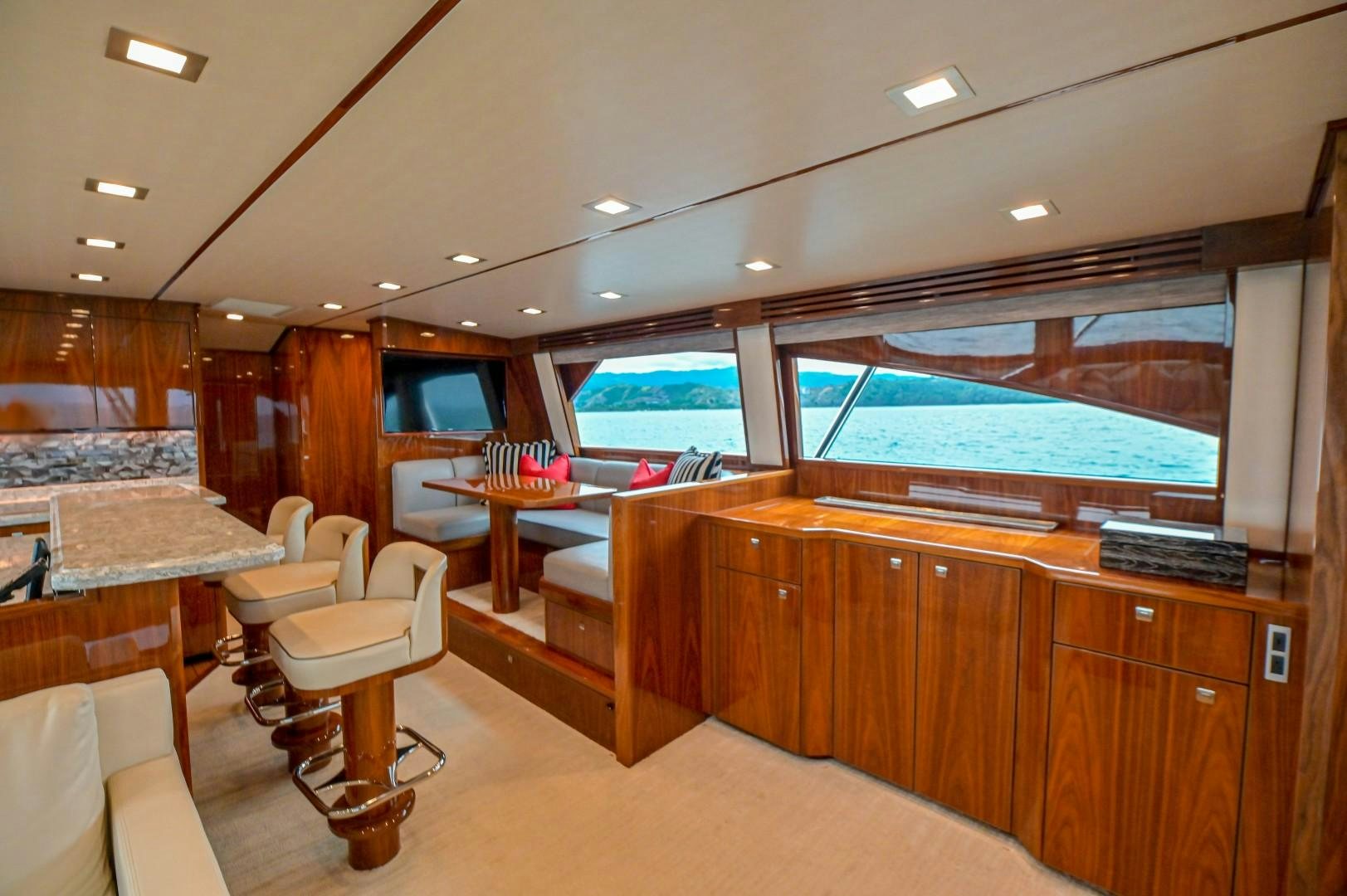 a room with a large window and a table with chairs and a large window aboard GOOSE Yacht for Sale