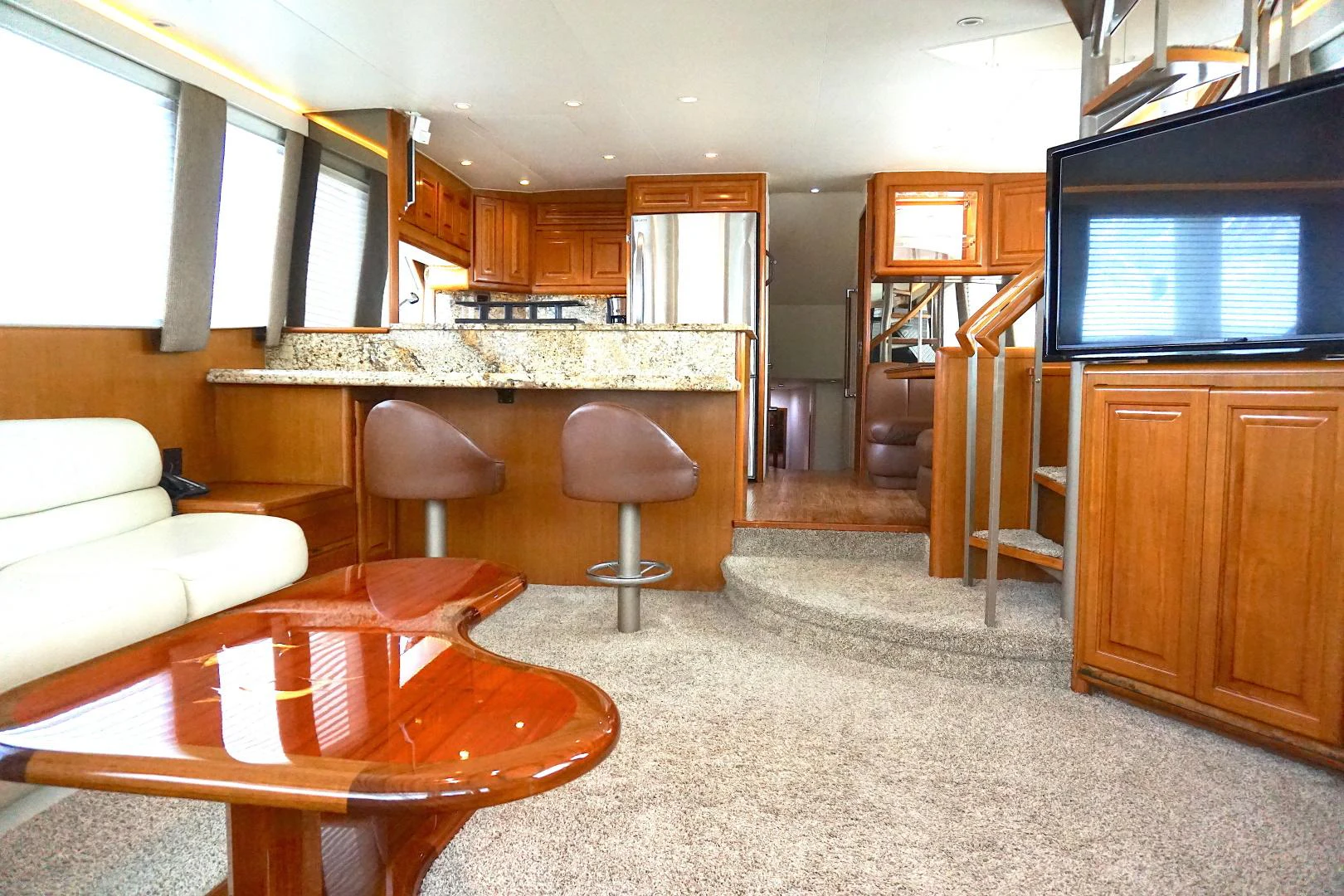 a living room with a table and chairs aboard CROWN ROYAL Yacht for Sale