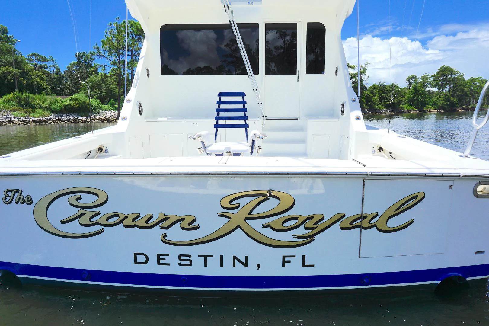 a white boat on a lake aboard CROWN ROYAL Yacht for Sale