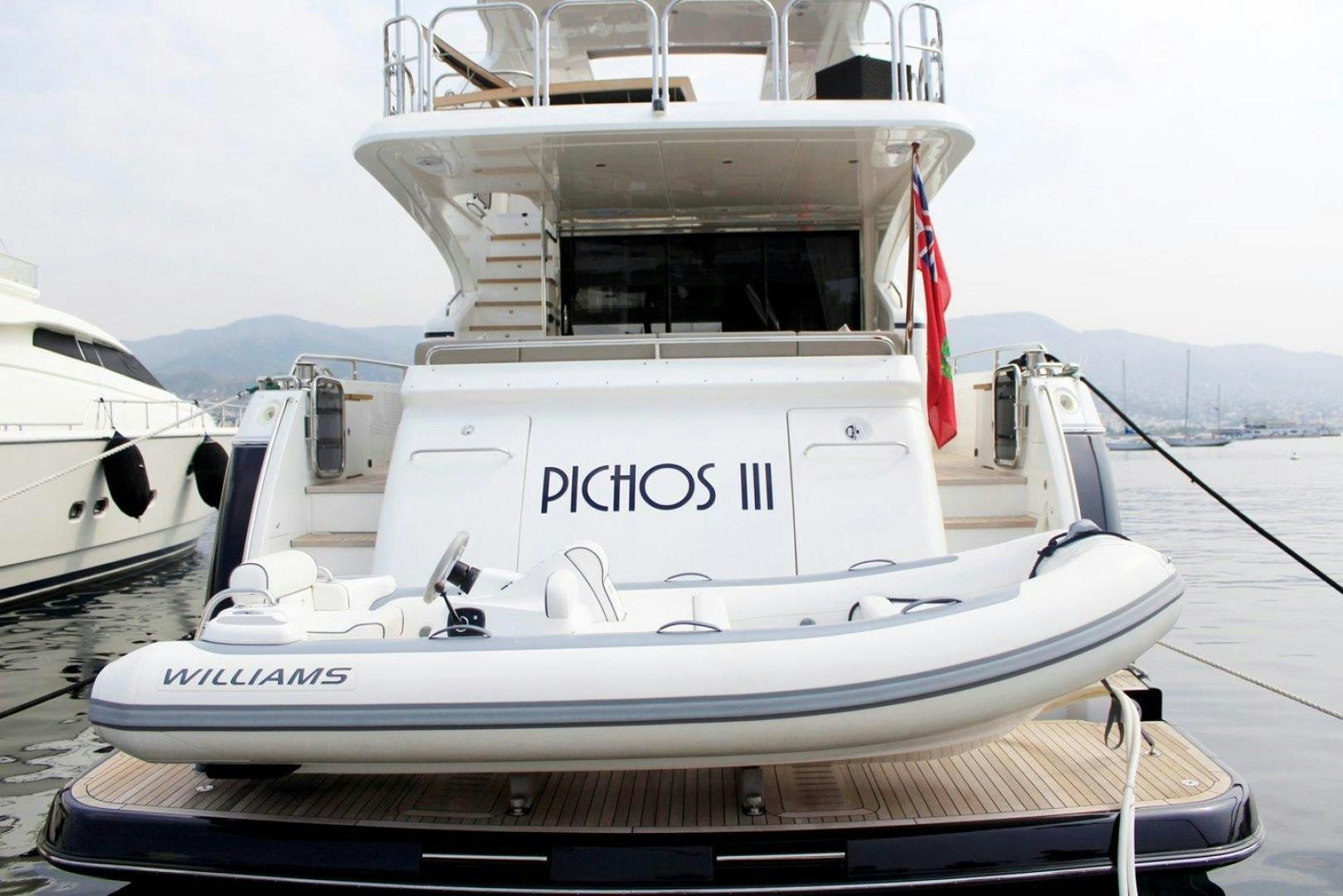 a white boat on a dock aboard PICHOS III Yacht for Sale