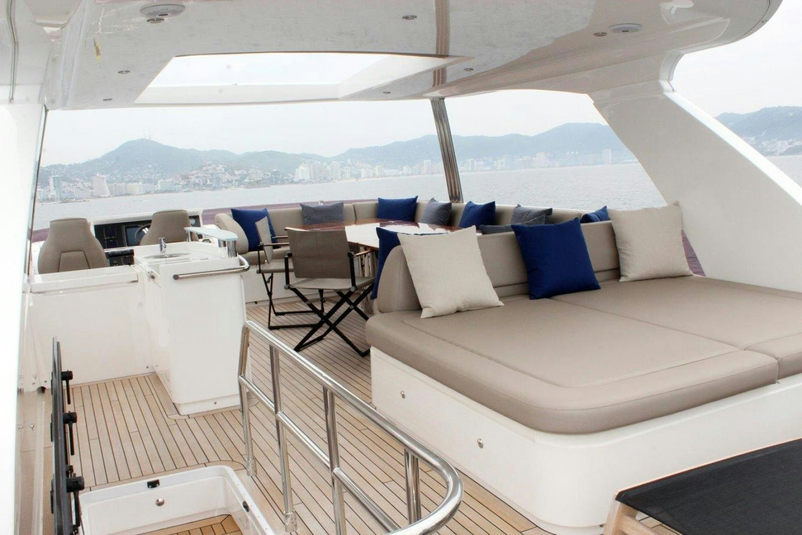 a room with a bed and a chair aboard PICHOS III Yacht for Sale