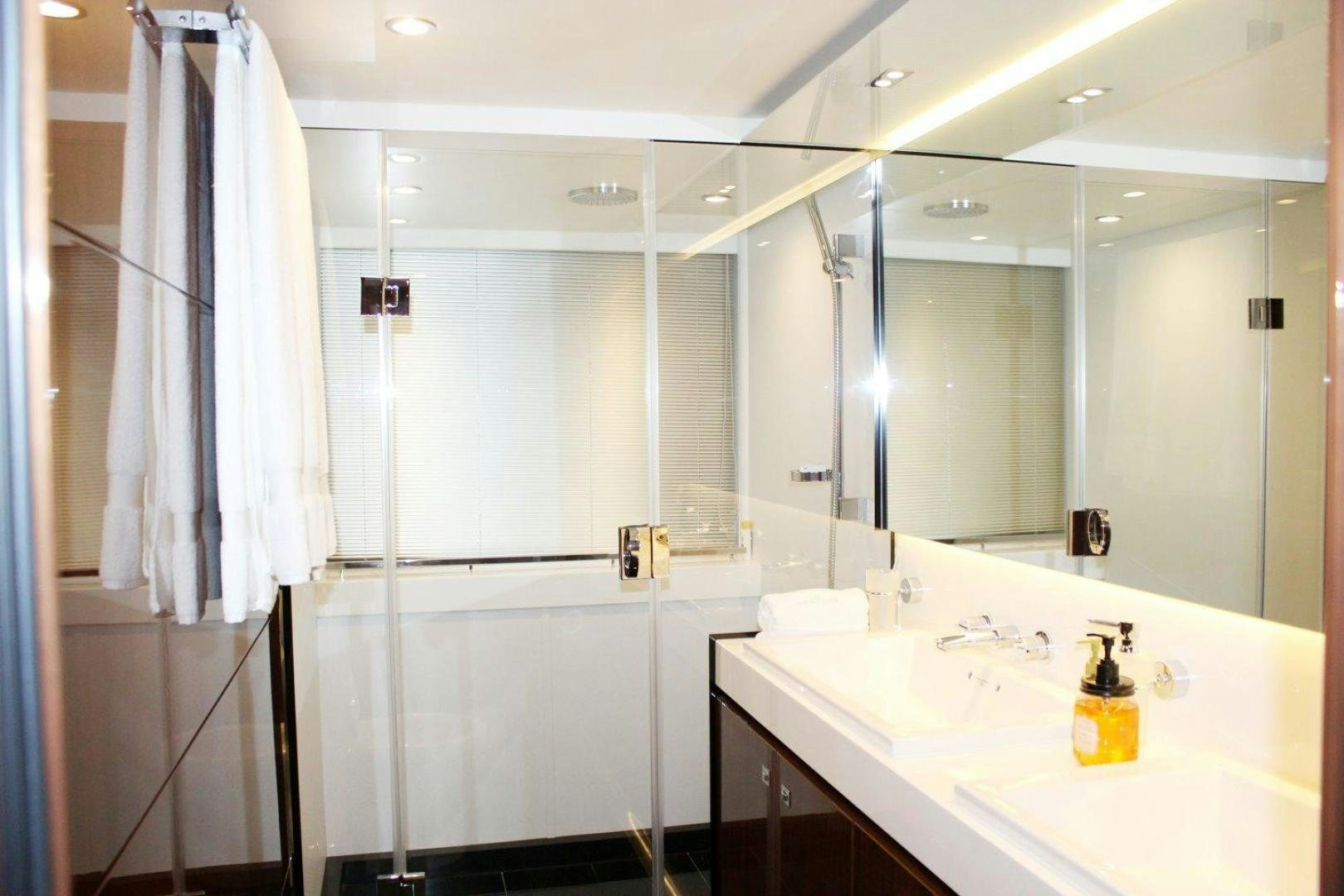 a bathroom with a large mirror aboard PICHOS III Yacht for Sale