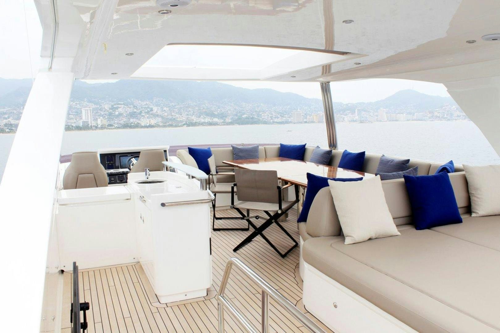 a room with a couch and a table and chairs aboard PICHOS III Yacht for Sale