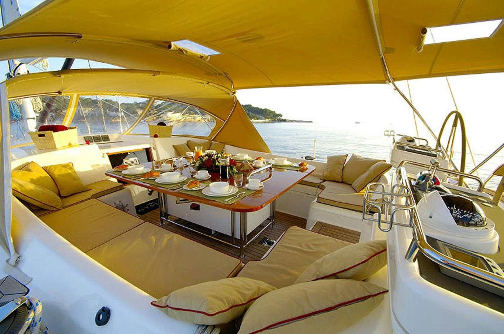 a large white tent with a table and chairs in it aboard HOLO KAI Yacht for Sale