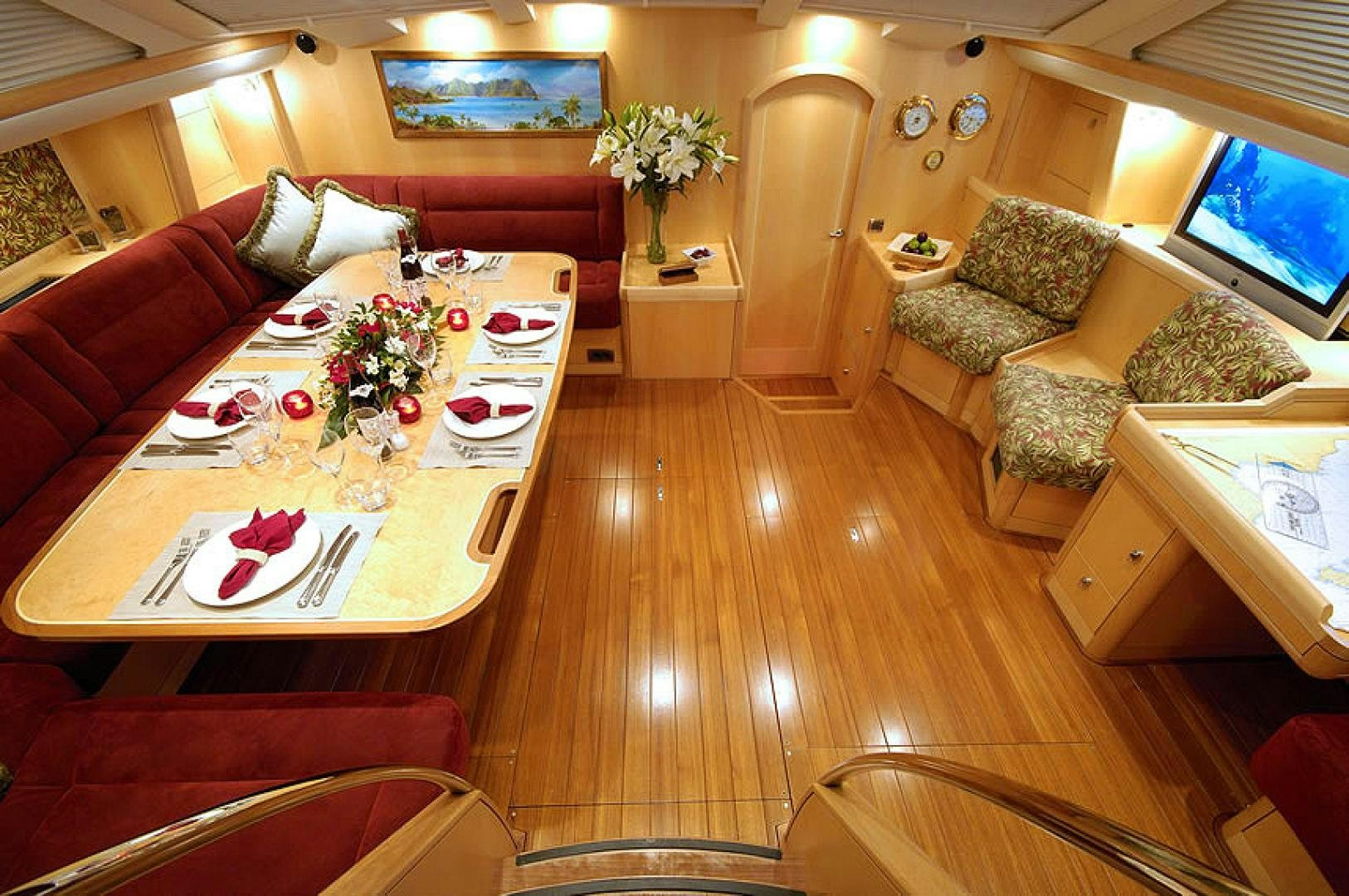a living room with a table and couches aboard HOLO KAI Yacht for Sale