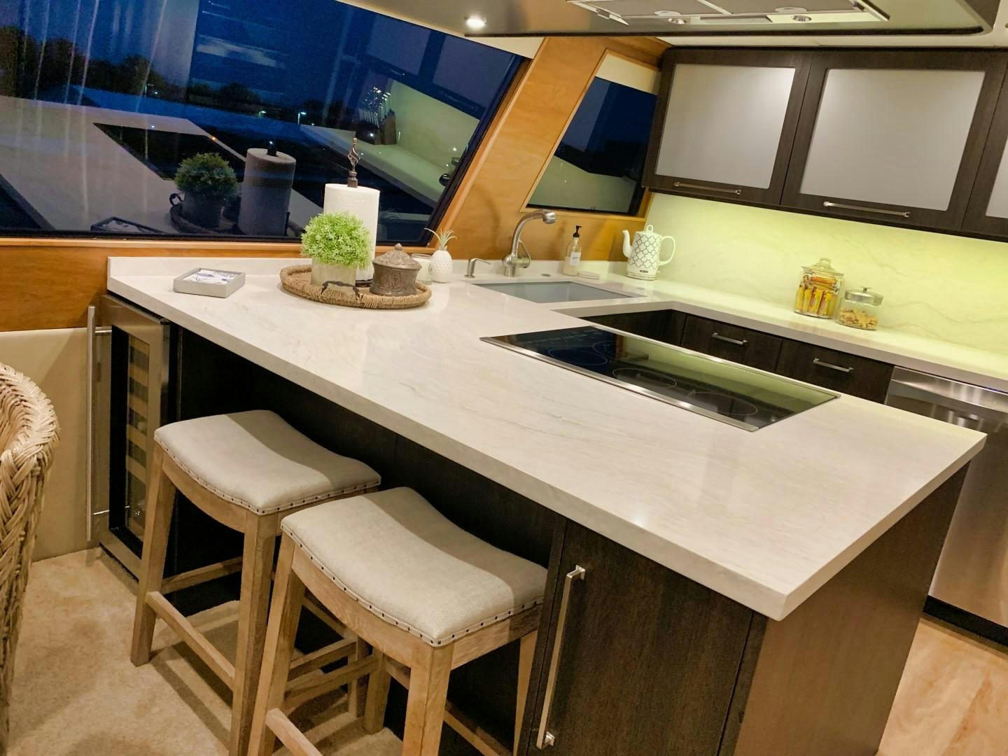 a kitchen with a table and stools aboard SIMPLICITY Yacht for Sale