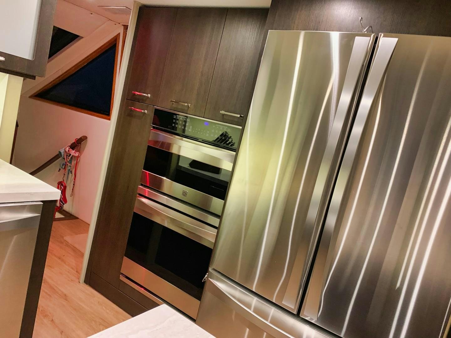 a stainless steel refrigerator in a kitchen aboard SIMPLICITY Yacht for Sale
