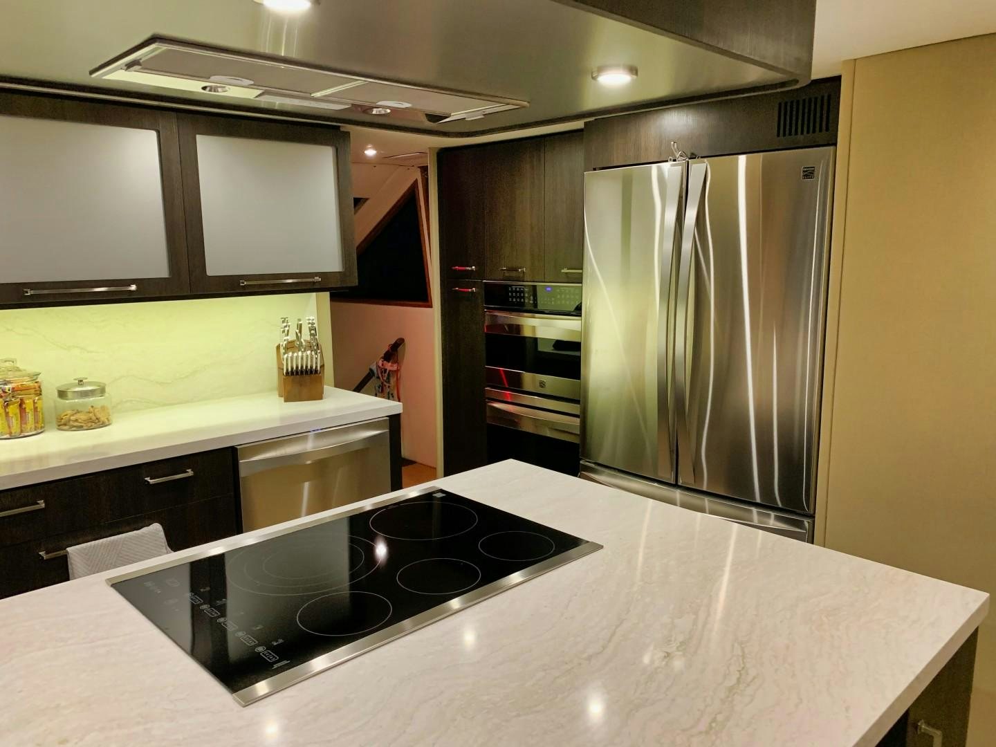 a kitchen with a stainless steel refrigerator aboard SIMPLICITY Yacht for Sale