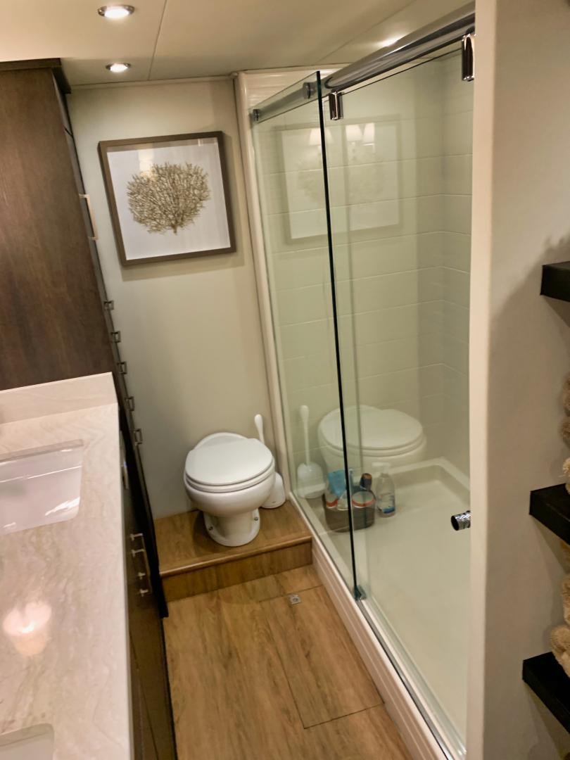 a bathroom with a glass shower aboard SIMPLICITY Yacht for Sale