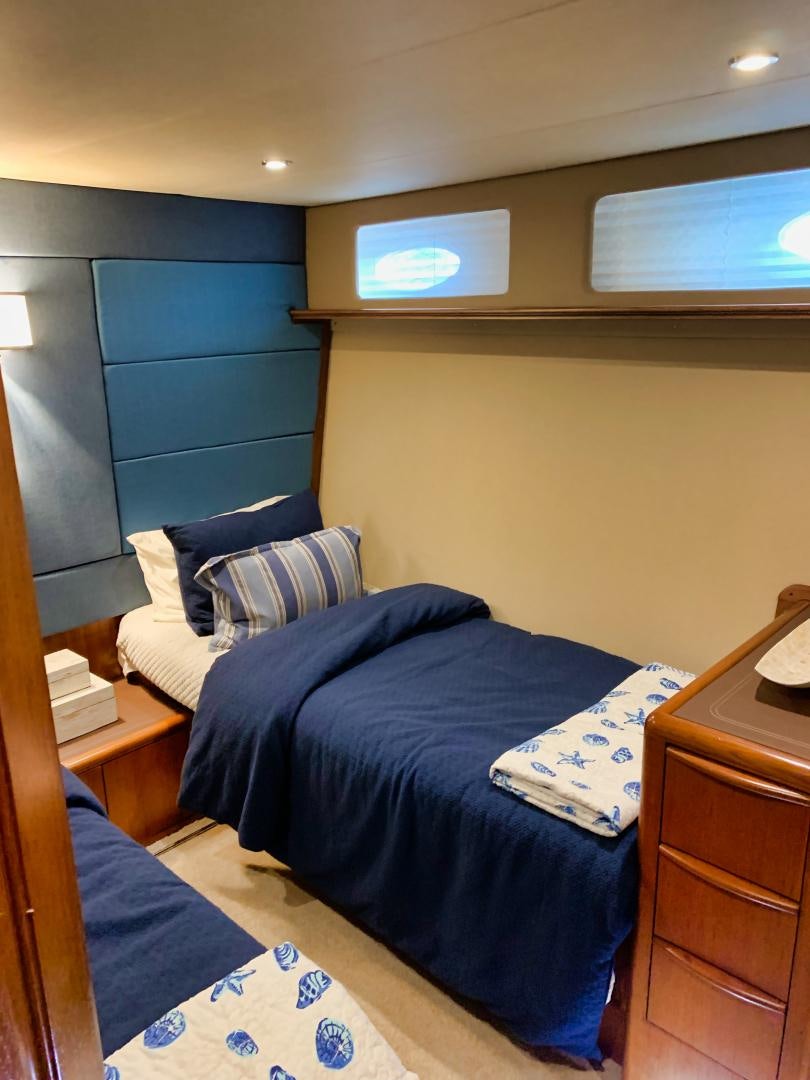 a bed with a blue comforter aboard SIMPLICITY Yacht for Sale