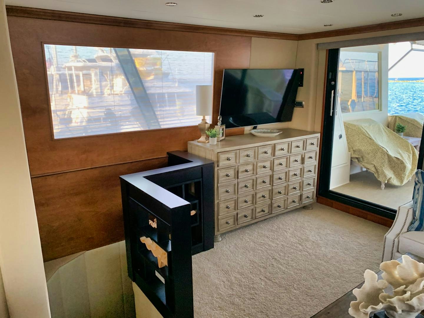 a room with a tv and dresser aboard SIMPLICITY Yacht for Sale