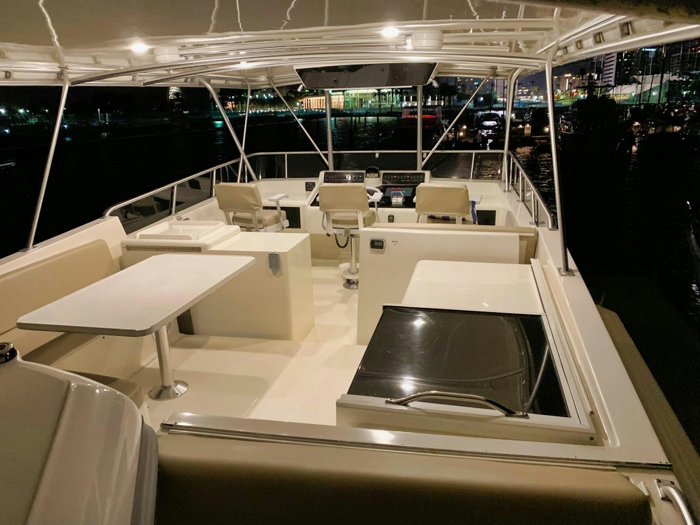 a room with tables and chairs aboard SIMPLICITY Yacht for Sale