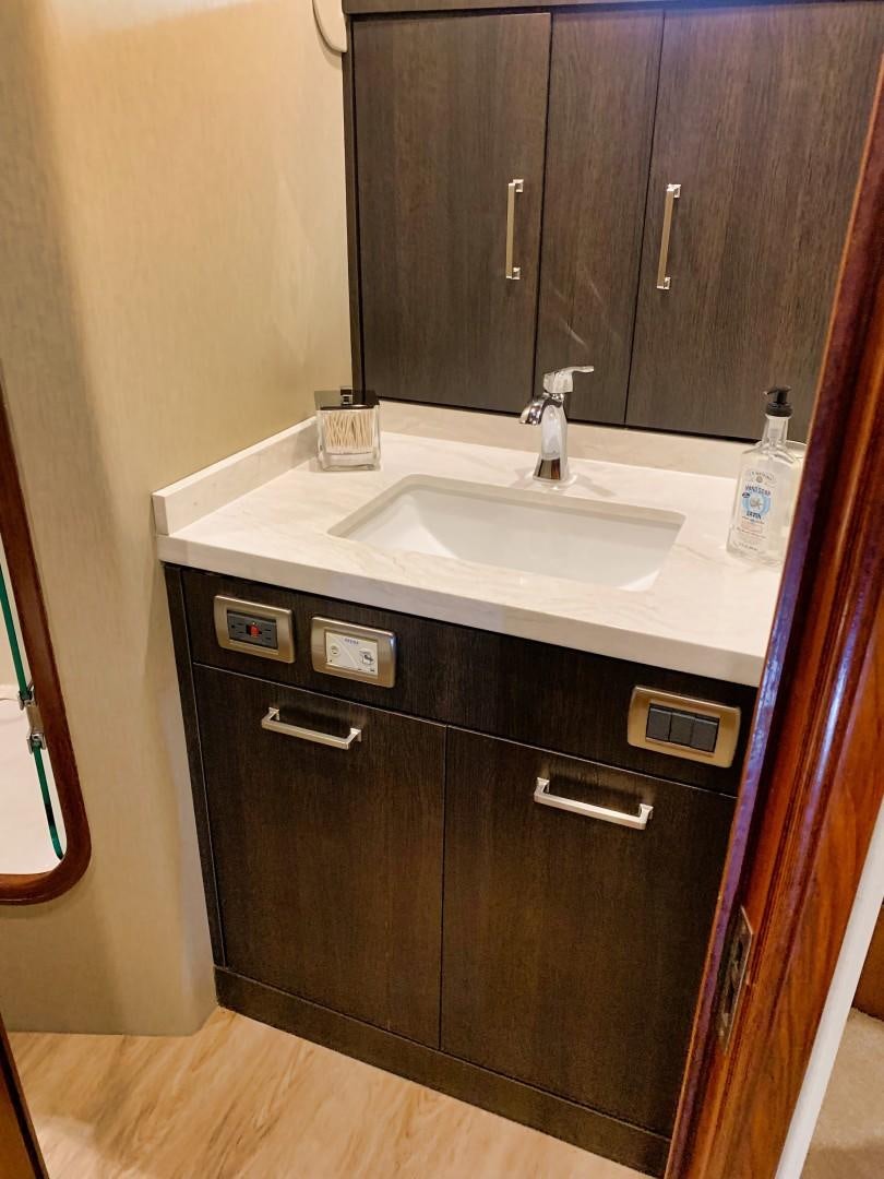 a bathroom with a sink and a mirror aboard SIMPLICITY Yacht for Sale