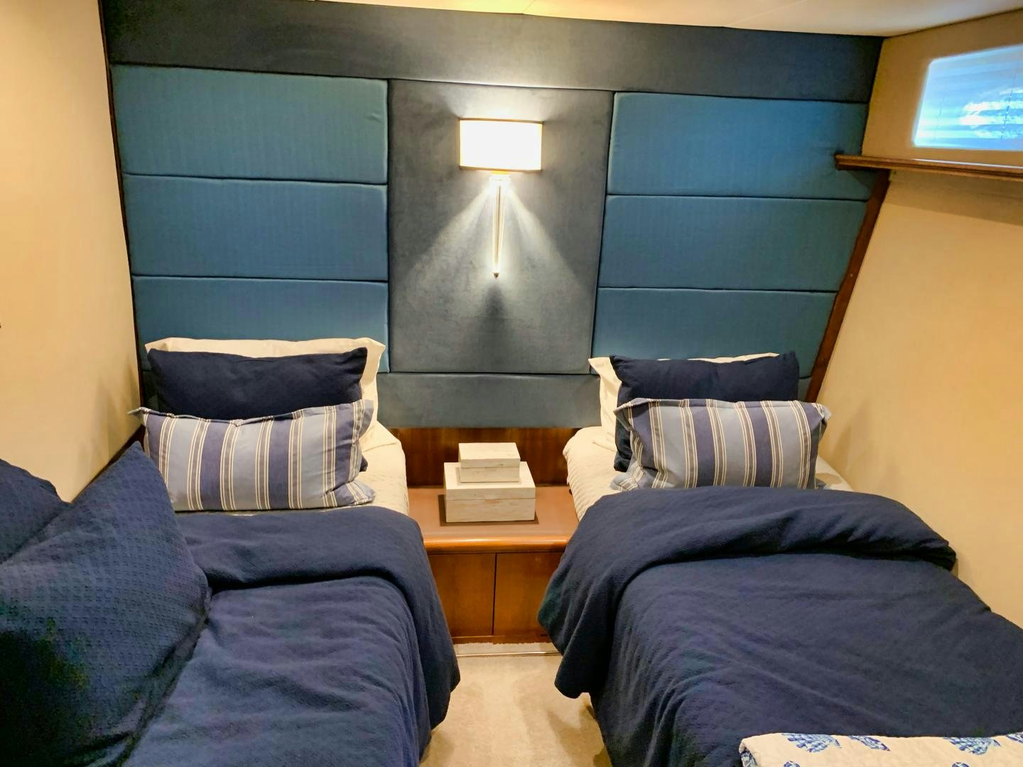 a room with a bed and a lamp on the wall aboard SIMPLICITY Yacht for Sale