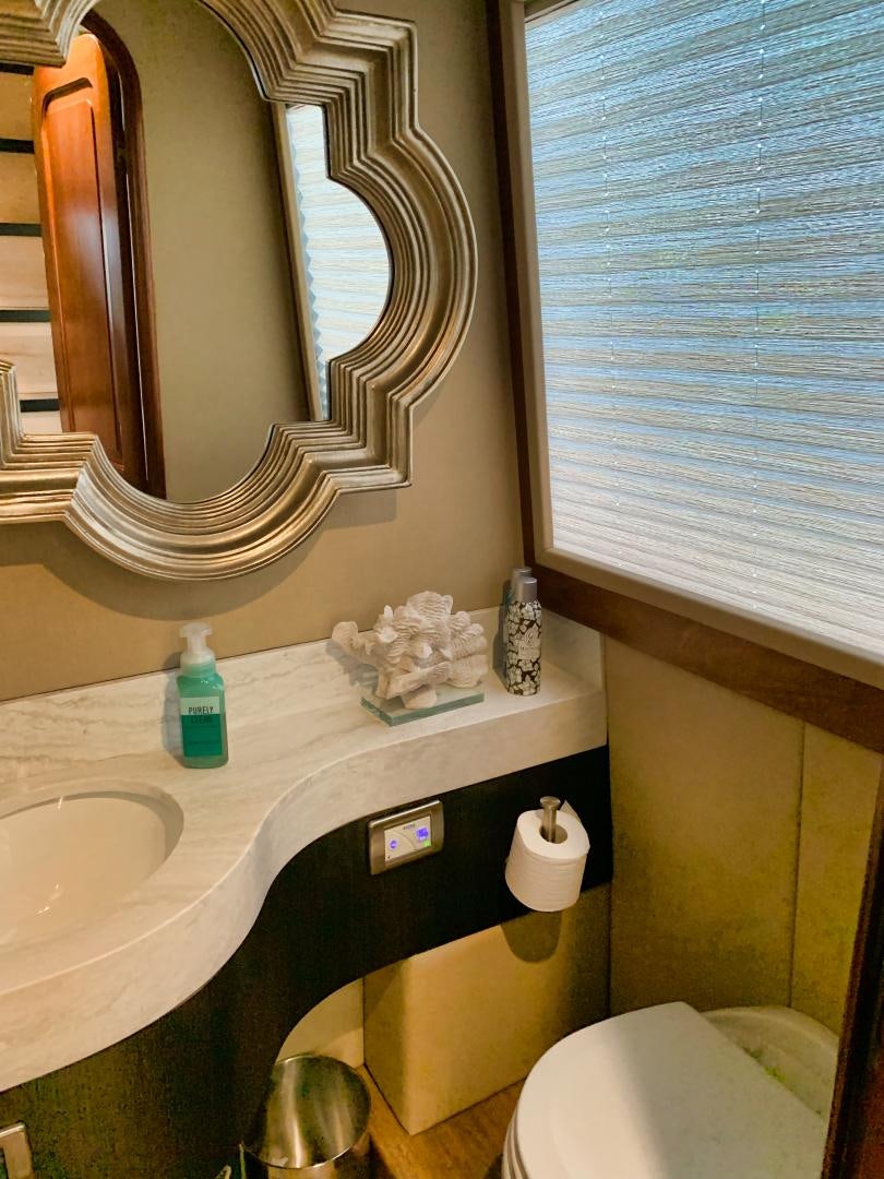 a bathroom with a mirror and a sink aboard SIMPLICITY Yacht for Sale