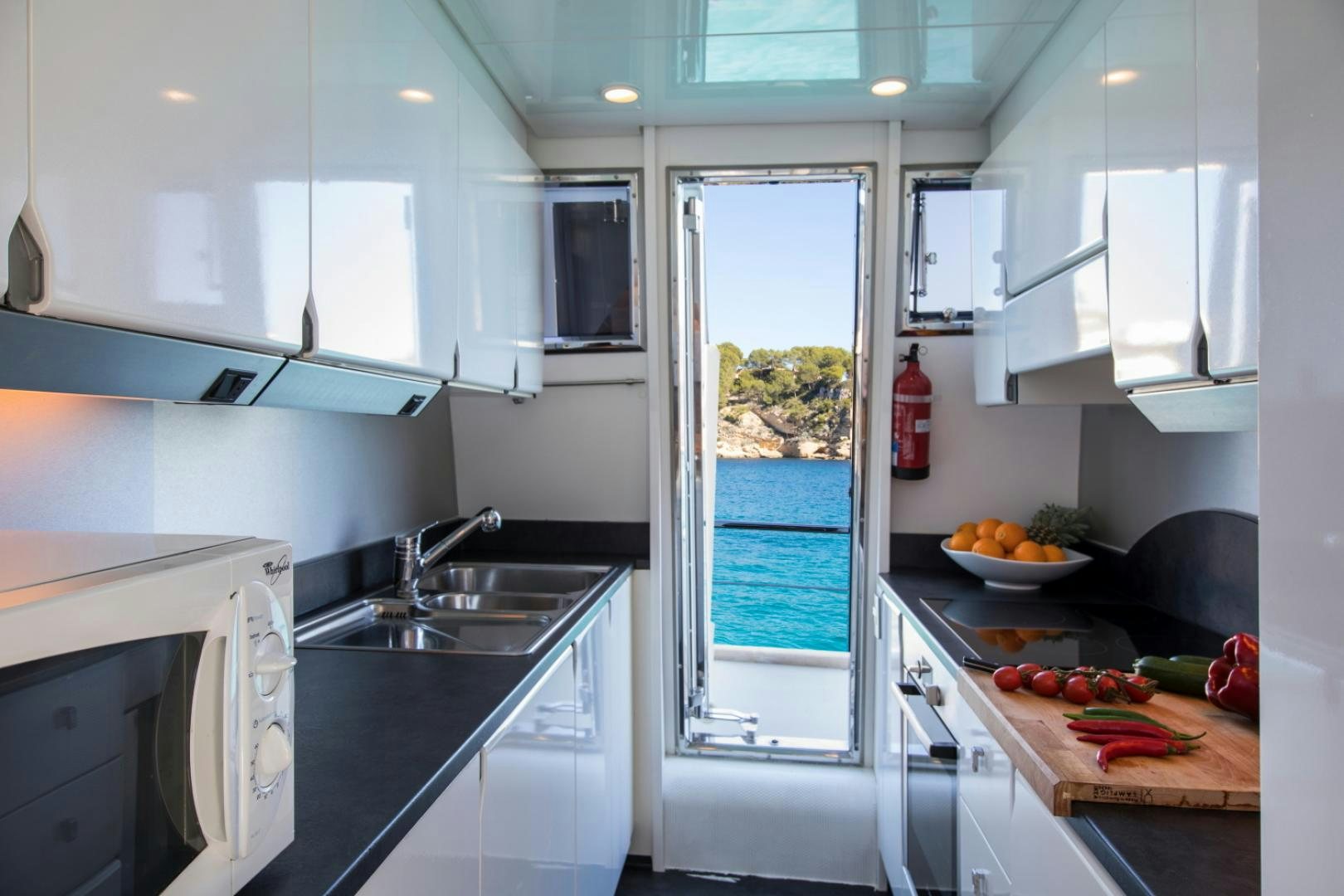 a kitchen with white cabinets aboard MYTHOS Yacht for Sale