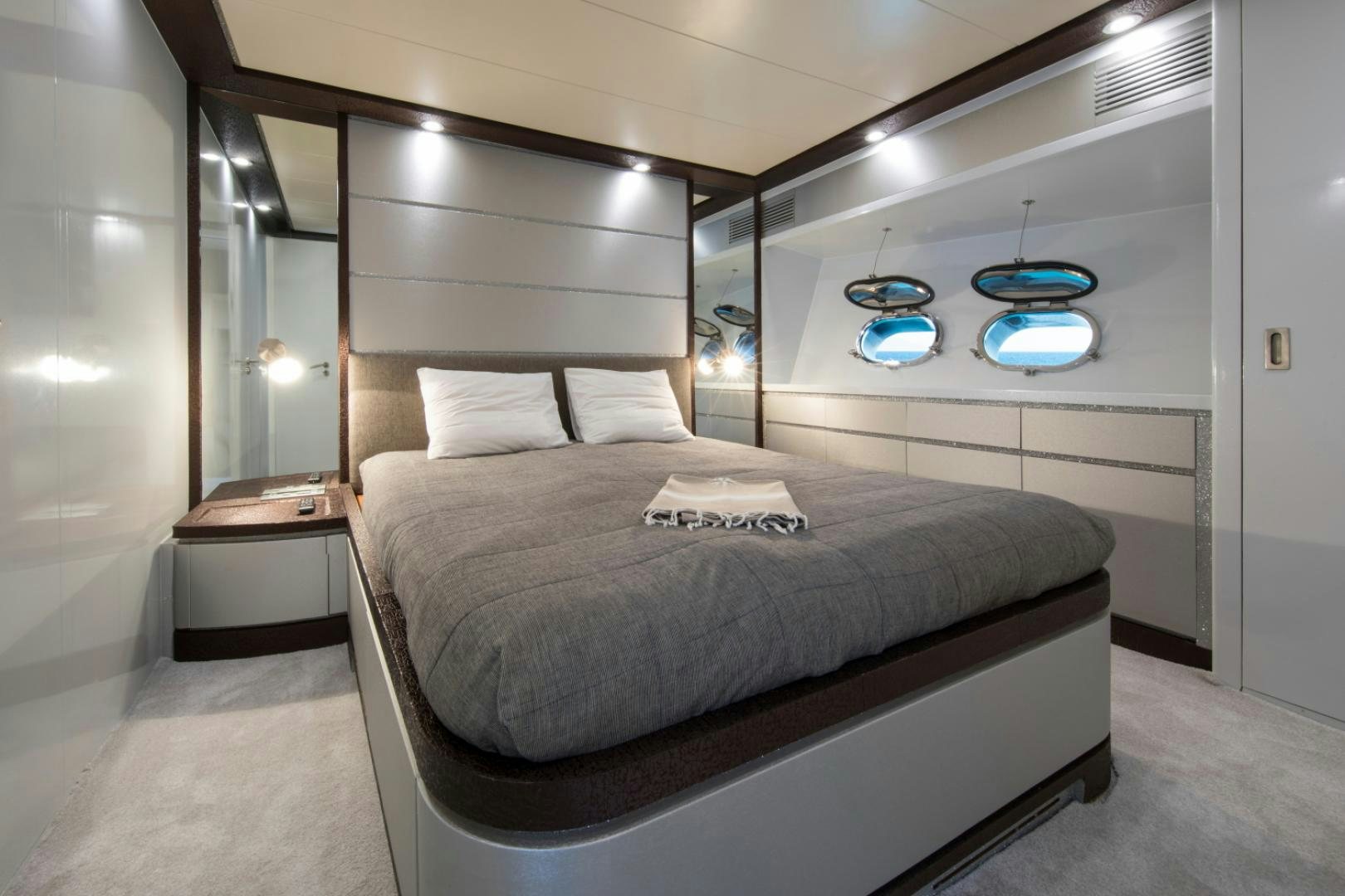 a bed with a black frame aboard MYTHOS Yacht for Sale