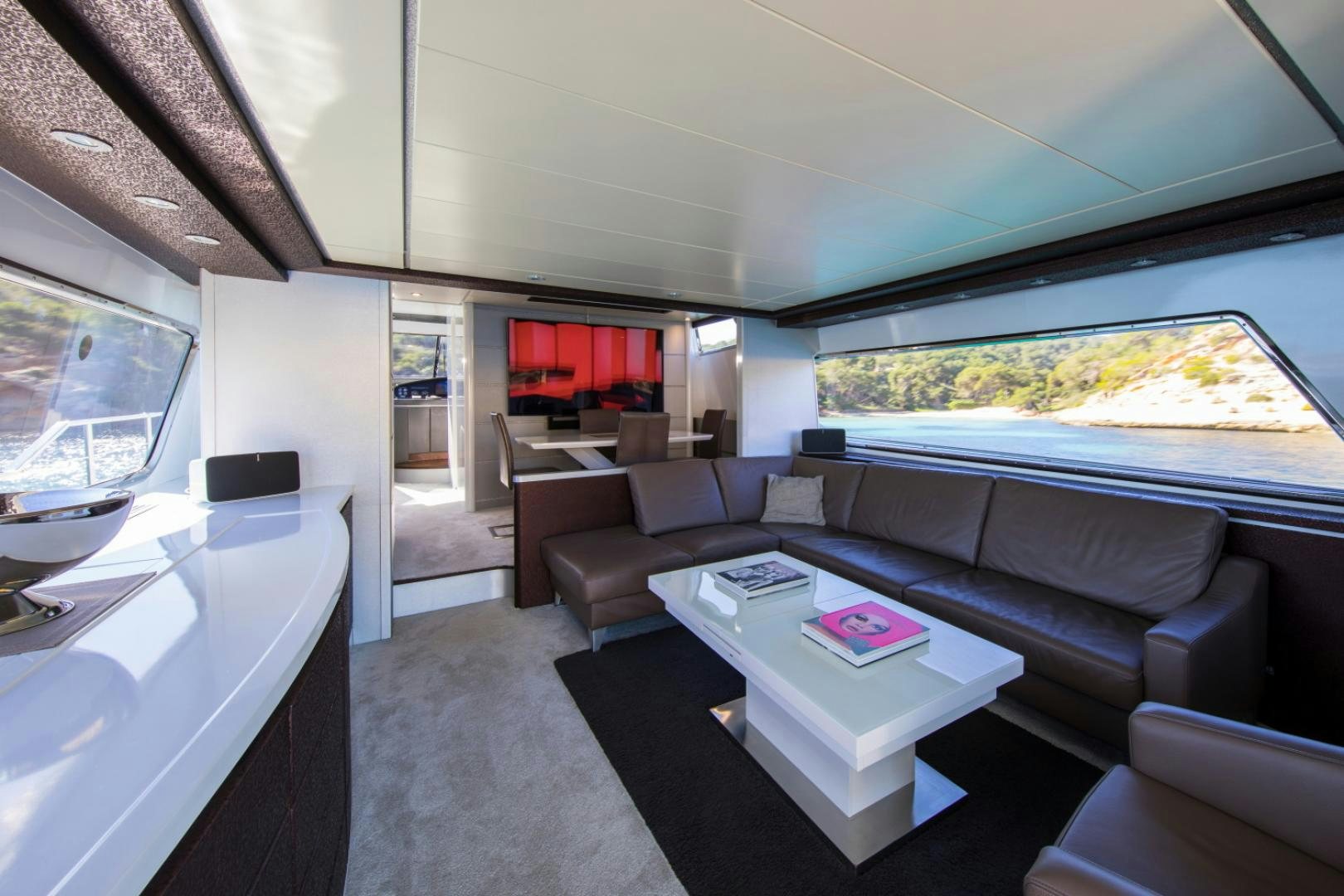 a living room with a large screen aboard MYTHOS Yacht for Sale