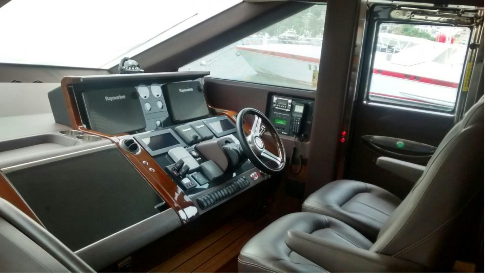 a car interior with a steering wheel and dashboard aboard PISCHOS III Yacht for Sale