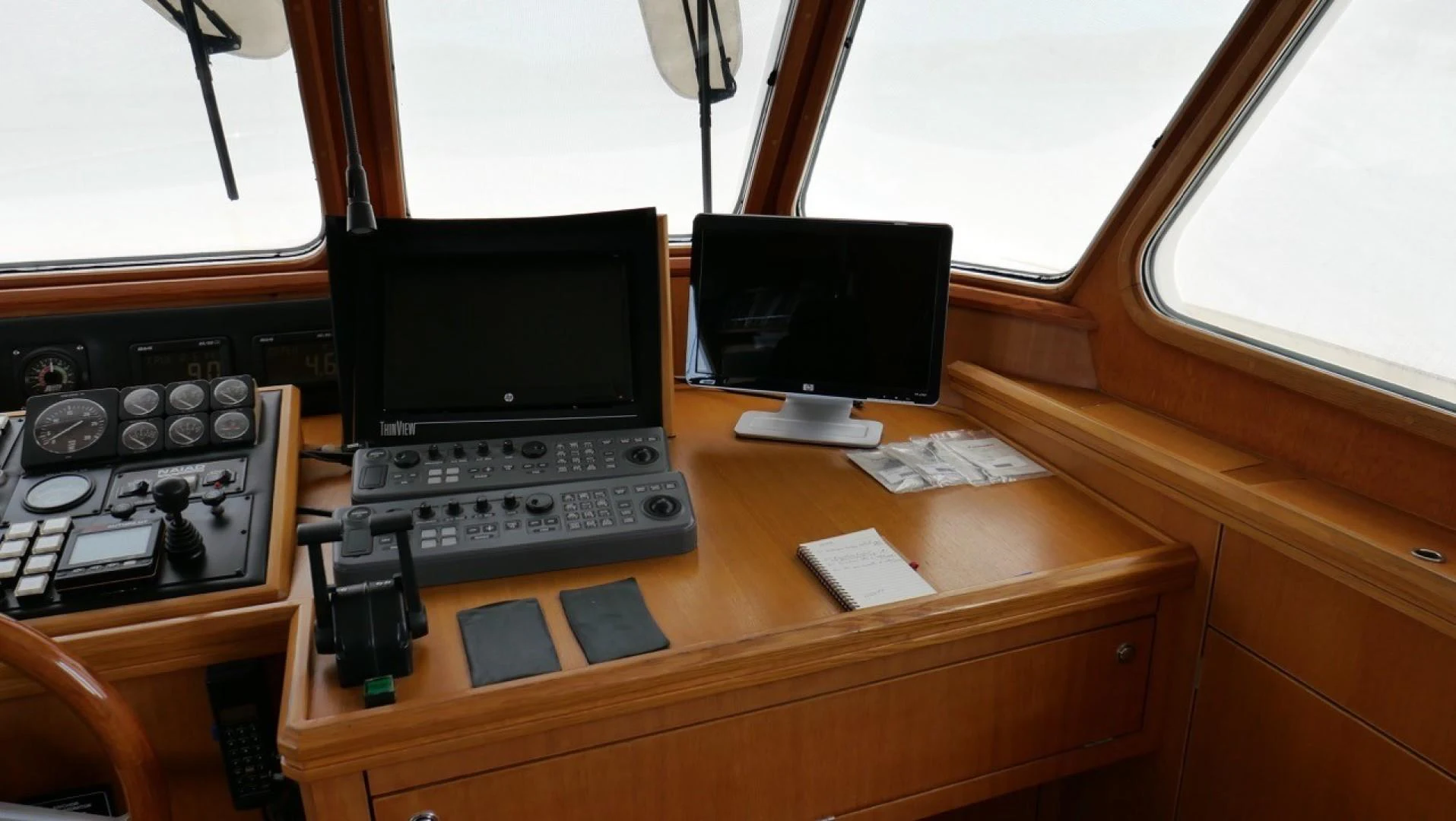 a desk with a laptop and a phone on it aboard PELAGIAL Yacht for Sale