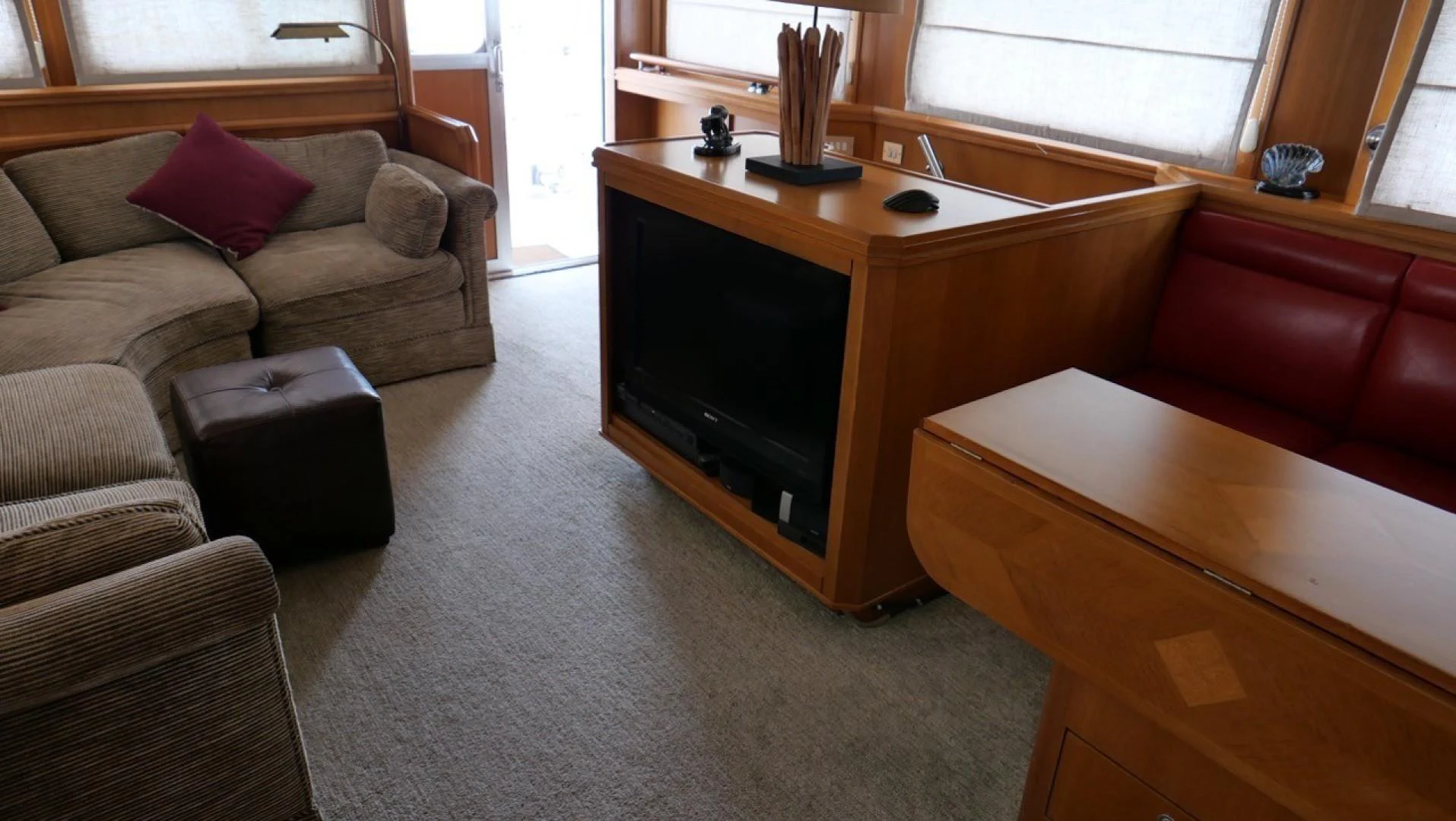 a living room with a tv and couches aboard PELAGIAL Yacht for Sale