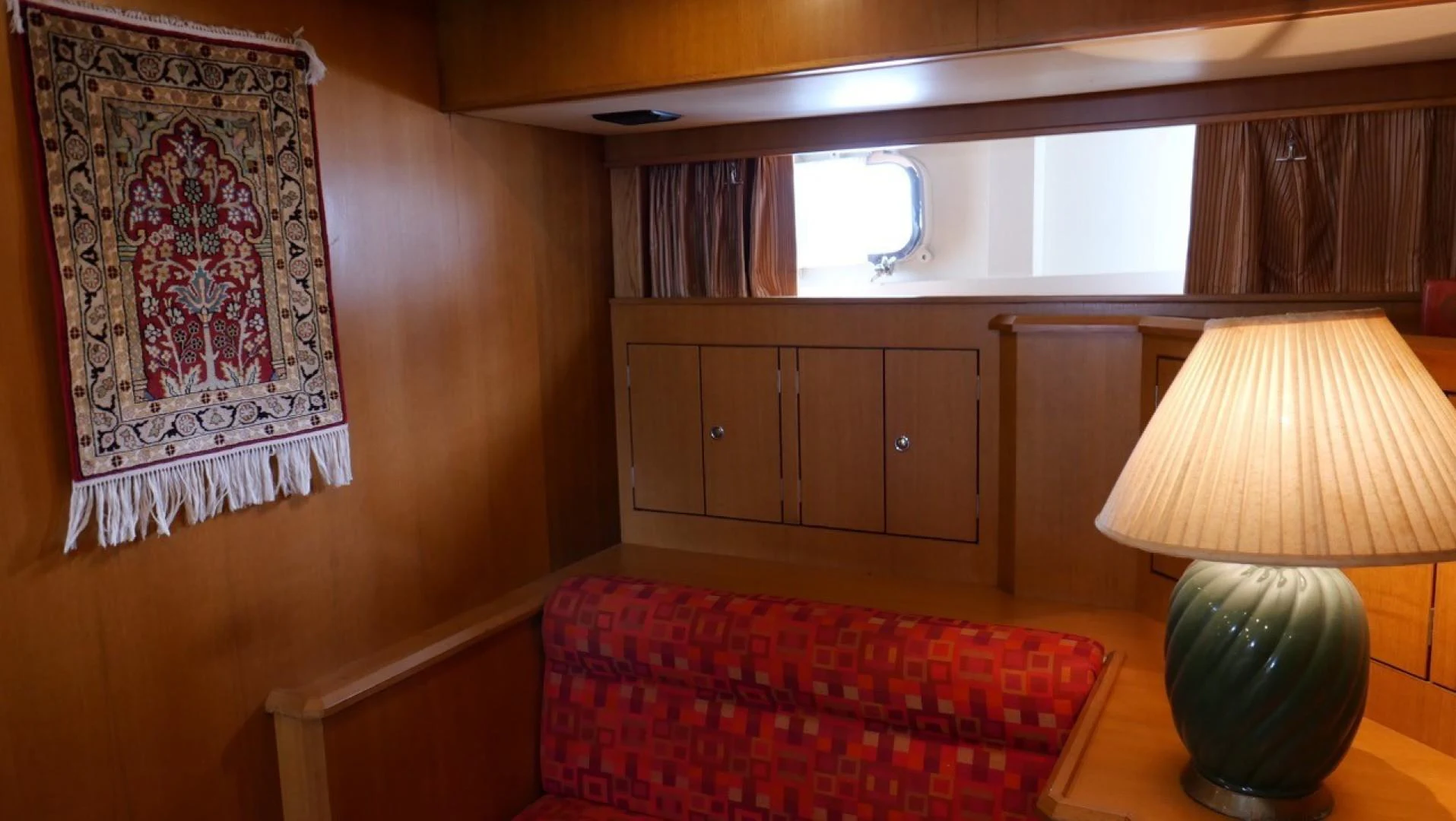 a room with a bed and a lamp aboard PELAGIAL Yacht for Sale