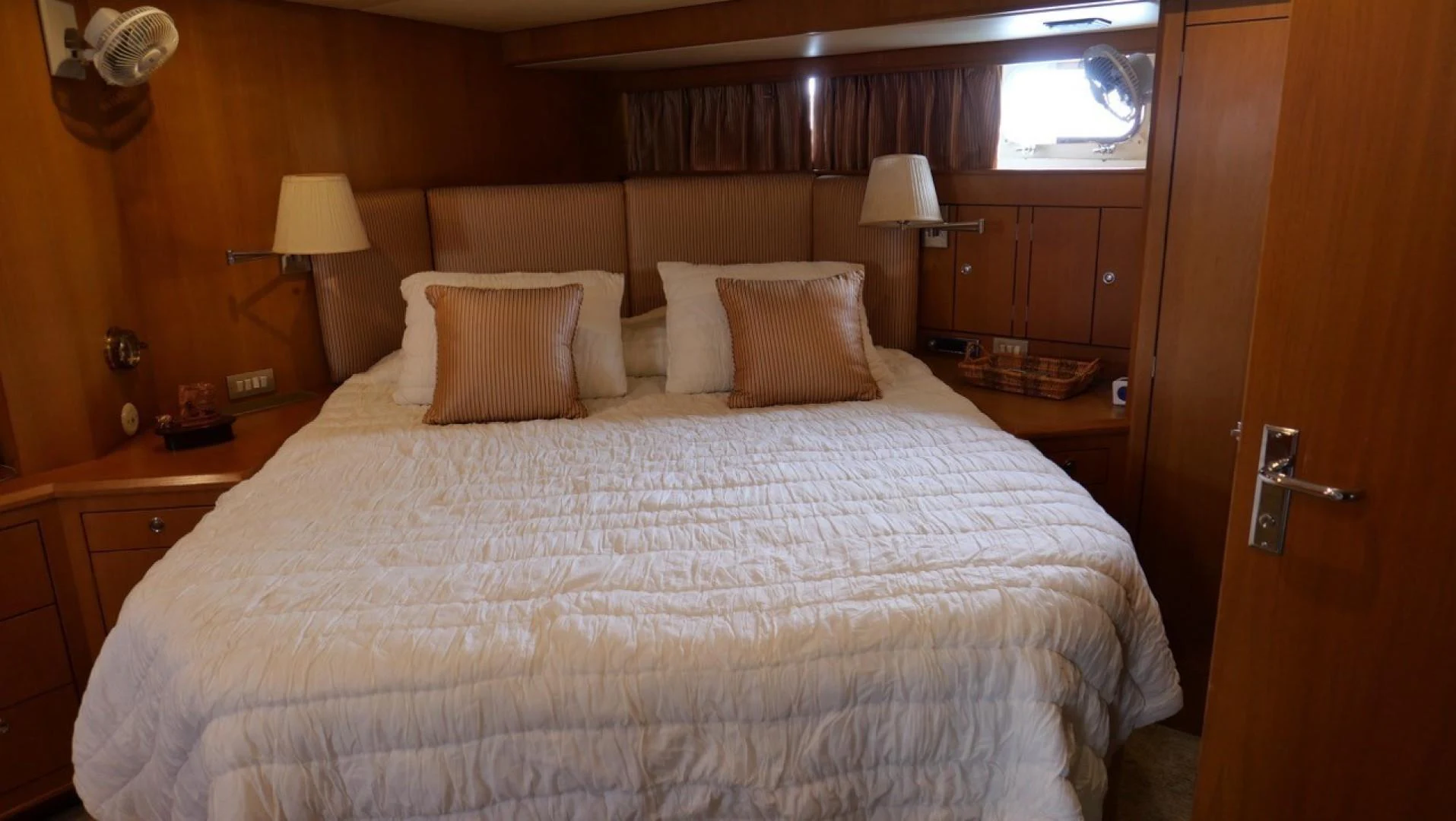 a bed with white sheets and pillows aboard PELAGIAL Yacht for Sale