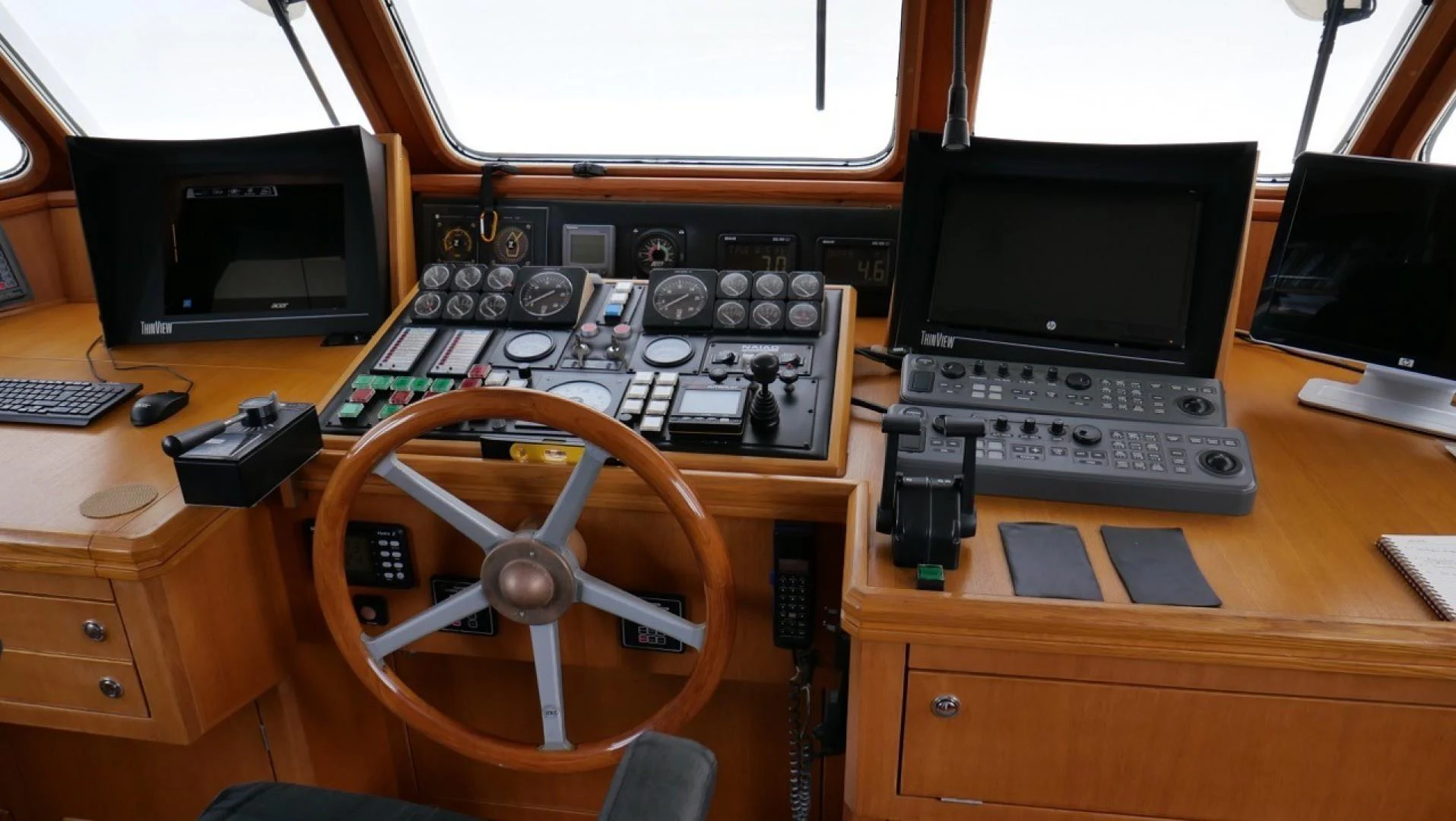 a desk with a computer and a guitar aboard PELAGIAL Yacht for Sale