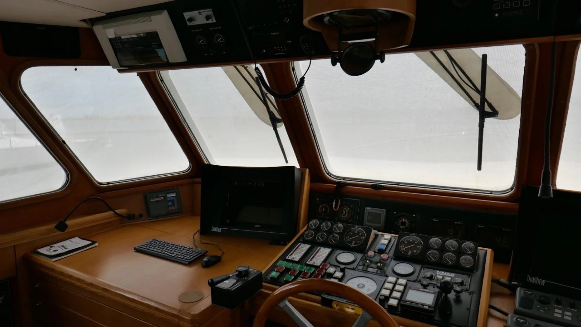 a desk with a computer and a radio aboard PELAGIAL Yacht for Sale