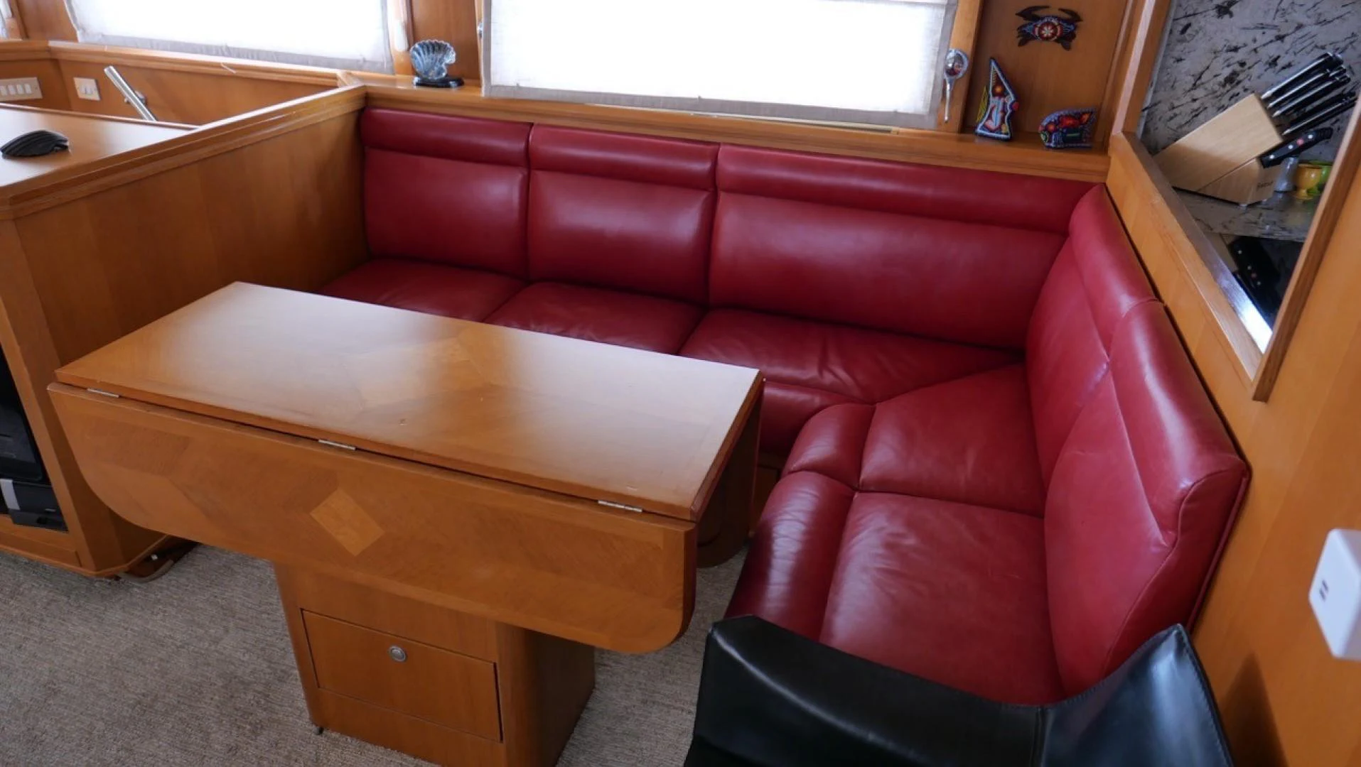 a red couch in a room aboard PELAGIAL Yacht for Sale