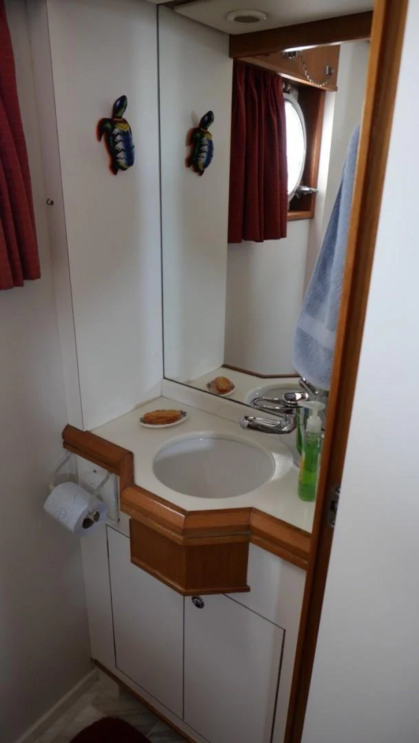 a bathroom with a sink and a mirror aboard PELAGIAL Yacht for Sale