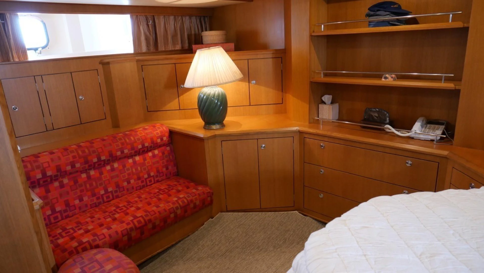 a bedroom with a bed and a lamp aboard PELAGIAL Yacht for Sale