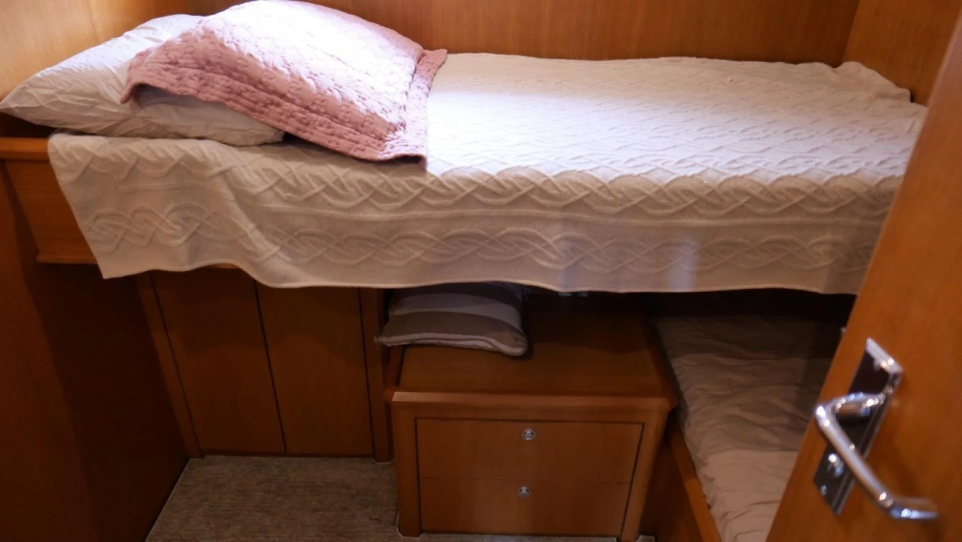 a bed with pink sheets aboard PELAGIAL Yacht for Sale