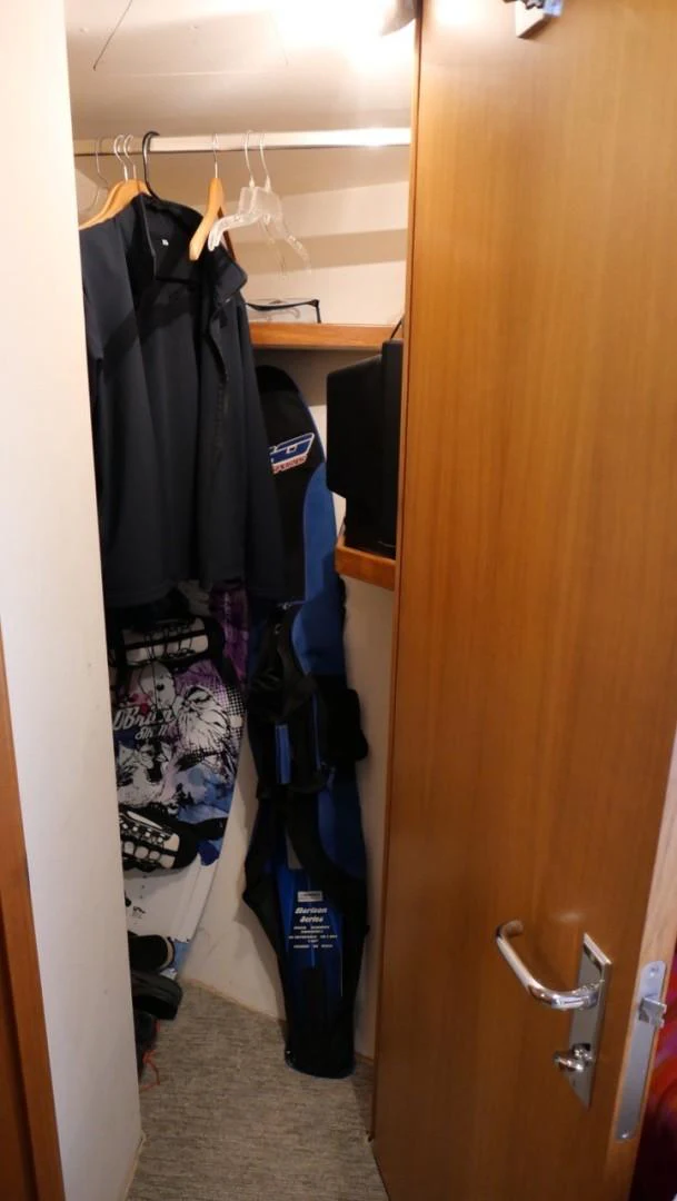 a closet with clothes on the wall aboard PELAGIAL Yacht for Sale