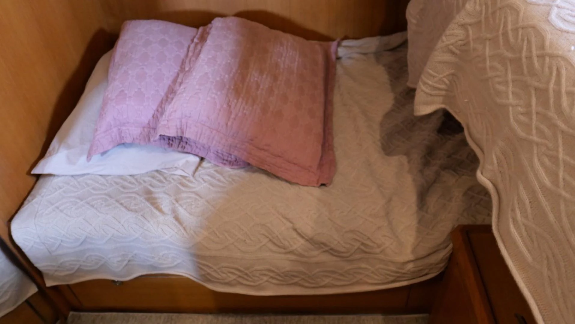 a bed with a pink pillow aboard PELAGIAL Yacht for Sale