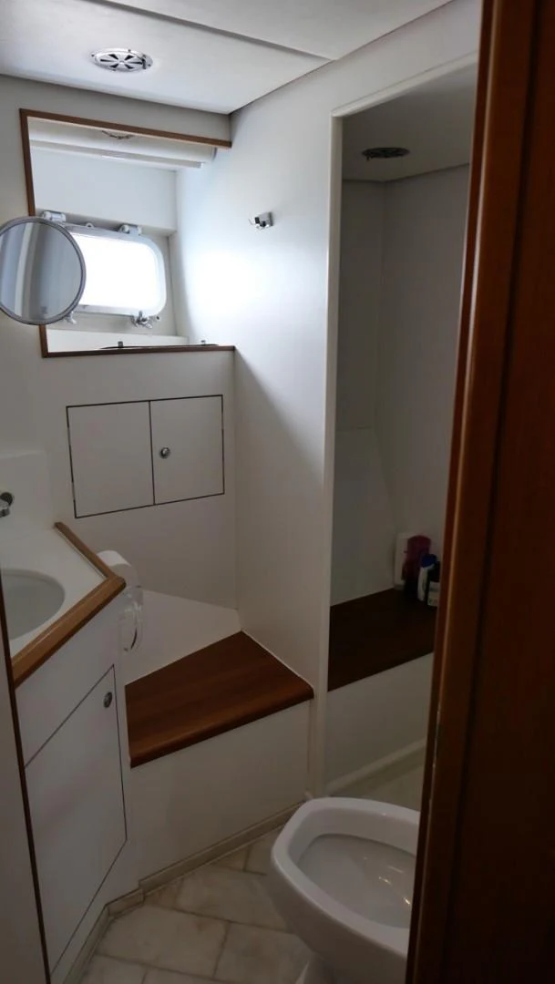 a bathroom with a toilet and a sink aboard PELAGIAL Yacht for Sale