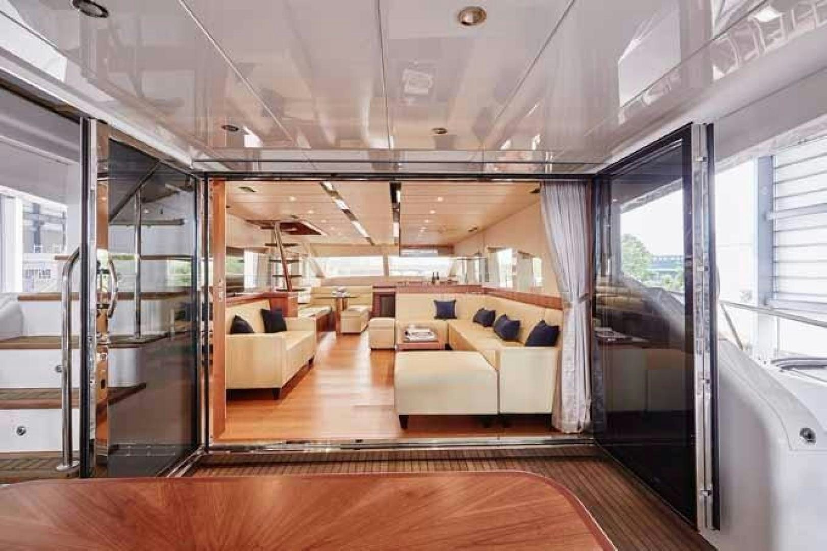 a room with a couch and a table aboard JOHNSON 70 SKYLOUNGE NEW BUILD Yacht for Sale