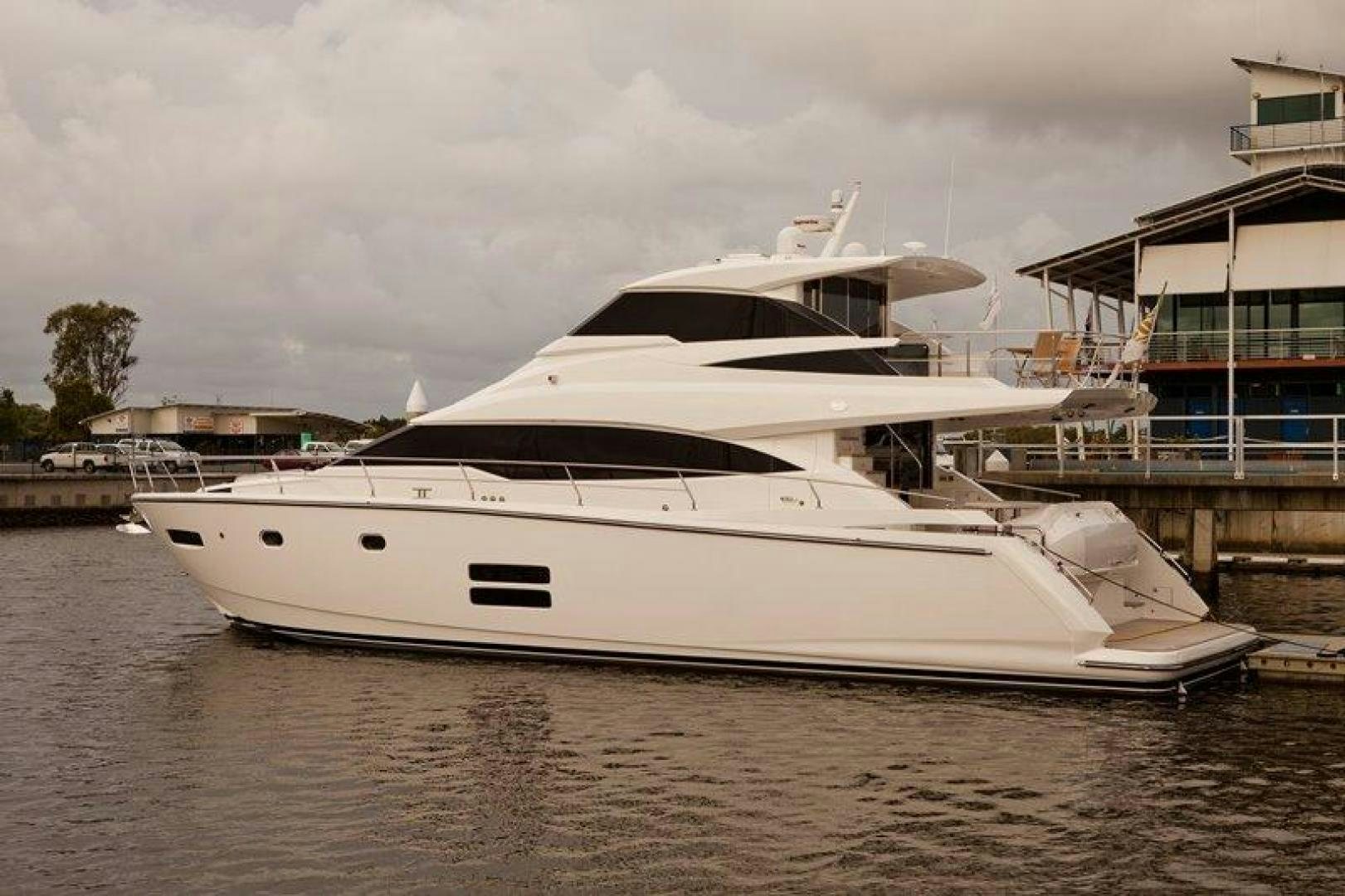 a white yacht docked aboard JOHNSON 70 SKYLOUNGE NEW BUILD Yacht for Sale