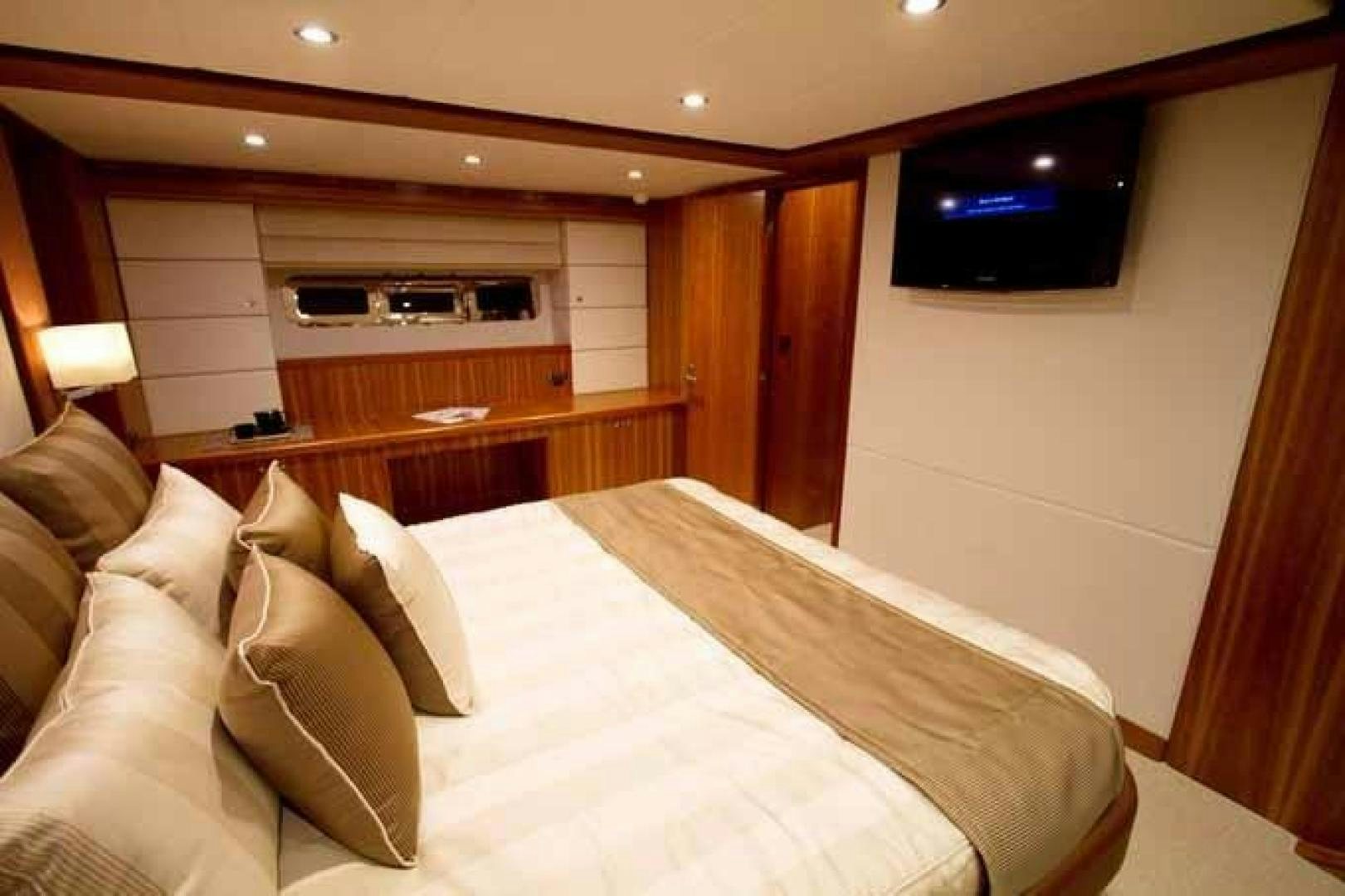 a large bed in a room aboard JOHNSON 70 SKYLOUNGE NEW BUILD Yacht for Sale