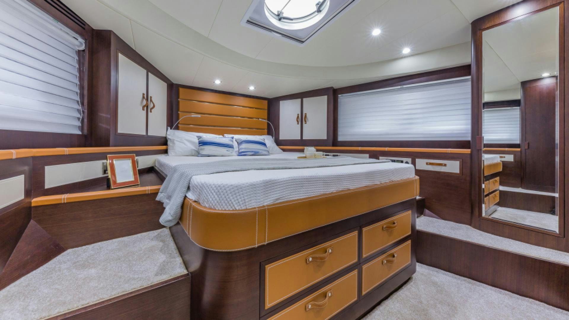 a room with a bed and a mirror aboard No Name Yacht for Sale